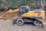 Mobilbagger Develon DX 210W-7 mit WOODY WH6-1 Z